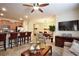 Open concept living room with tile flooring, kitchen bar, and plenty of natural light at 2919 Banana Palm Dr, Kissimmee, FL 34747