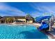 A resort-style pool featuring a fun water slide and lounge chairs is the perfect place to spend a sunny day at 2919 Banana Palm Dr, Kissimmee, FL 34747