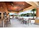Outdoor covered bar with televisions, ceiling fans, and seating poolside at 2919 Banana Palm Dr, Kissimmee, FL 34747