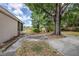 Spacious backyard with mature trees, a patio and lush greenery at 3025 Bon Air Dr, Orlando, FL 32818