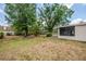 An exterior showing the property's backyard featuring mature trees and grass at 3025 Bon Air Dr, Orlando, FL 32818