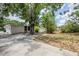 A sprawling backyard with mature trees and an empty lot ready for its next owner to customize at 3025 Bon Air Dr, Orlando, FL 32818