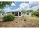 The exterior of this charming home features a spacious backyard ready for relaxation and entertaining at 3025 Bon Air Dr, Orlando, FL 32818
