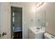 This bathroom features a white vanity with an undermount sink and vinyl flooring at 3025 Bon Air Dr, Orlando, FL 32818