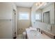Well lit bathroom with a window and a cherry vanity at 3025 Bon Air Dr, Orlando, FL 32818