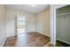 Bedroom with hardwood floors, a closet and easy access to the porch at 3025 Bon Air Dr, Orlando, FL 32818