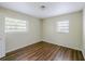 This bedroom has two windows with great natural light and hardwood flooring at 3025 Bon Air Dr, Orlando, FL 32818