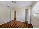 A bedroom is shown with hardwood floors, a closet, and a window with blinds at 3025 Bon Air Dr, Orlando, FL 32818