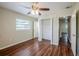 A bedroom with a closet, hardwood floors, and a ceiling fan at 3025 Bon Air Dr, Orlando, FL 32818