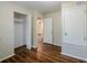 A bedroom with hardwood floors, a closet, and an open doorway at 3025 Bon Air Dr, Orlando, FL 32818