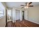 This bedroom has hardwood floors, a ceiling fan, a closet and easy access to the bathroom at 3025 Bon Air Dr, Orlando, FL 32818