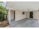 Exterior view of a covered carport with a dark-colored entry door, side door and overhead lighting at 3025 Bon Air Dr, Orlando, FL 32818