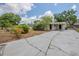View of a single-story home featuring a long driveway leading to a covered carport with dual entry doors at 3025 Bon Air Dr, Orlando, FL 32818