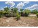 Modest home featuring a neutral-toned exterior and mature landscaping under a partly cloudy sky at 3025 Bon Air Dr, Orlando, FL 32818