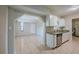 Features an open-concept layout with tile floors, a stainless steel dishwasher, and bright white cabinetry at 3025 Bon Air Dr, Orlando, FL 32818