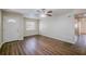 Cozy living room with dark hardwood floors, featuring a ceiling fan and natural light from a nearby window at 3025 Bon Air Dr, Orlando, FL 32818