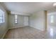 Spacious living room featuring tile flooring and natural light from two windows at 3025 Bon Air Dr, Orlando, FL 32818