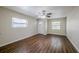 Bright living room with hardwood floors, ceiling fan, and plenty of natural light from the front door and windows at 3025 Bon Air Dr, Orlando, FL 32818