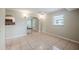 Bright living room featuring tile flooring, neutral walls, and arched entryway to the kitchen at 3025 Bon Air Dr, Orlando, FL 32818