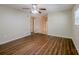 Open living room featuring dark-stained hardwood floors, a ceiling fan, and a view into the hallway at 3025 Bon Air Dr, Orlando, FL 32818