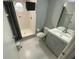 Bright bathroom featuring a walk-in shower with white tiles, and a gray vanity sink at 3147 Britannia Blvd # A, Kissimmee, FL 34747