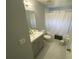 Bathroom with white tile flooring, shower-tub, and a gray vanity at 3147 Britannia Blvd # A, Kissimmee, FL 34747