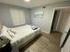Relaxing bedroom featuring a large window with natural light and hard wood floors at 3147 Britannia Blvd # A, Kissimmee, FL 34747