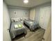 Bright bedroom with two twin beds, hardwood floors, and a large closet at 3147 Britannia Blvd # A, Kissimmee, FL 34747