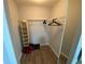 Walk-in closet with wooden floors, shelving, and hanging racks for clothes at 3147 Britannia Blvd # A, Kissimmee, FL 34747