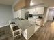 Updated kitchen featuring granite countertops, stainless appliances, and a breakfast bar at 3147 Britannia Blvd # A, Kissimmee, FL 34747