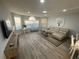 Open-concept living and dining area with sleek furniture and lots of natural light at 3147 Britannia Blvd # A, Kissimmee, FL 34747