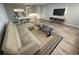 Bright living room with a couch, dining table, and gray flooring at 3147 Britannia Blvd # A, Kissimmee, FL 34747