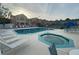Community pool and spa with lounge chairs surrounded by townhome buildings at 3147 Britannia Blvd # A, Kissimmee, FL 34747