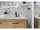 Close-up of bathroom vanity with wood grain cabinets, marble countertop, and modern fixtures at 320 Lakeview St # 214, Orlando, FL 32804