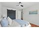 Bright bedroom with white walls, modern ceiling fan, and closet with barn doors at 320 Lakeview St # 214, Orlando, FL 32804