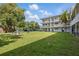 Apartment building with manicured lawn and mature trees, offering a serene outdoor space at 320 Lakeview St # 214, Orlando, FL 32804