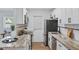 Modern kitchen featuring stainless steel appliances, stone countertops, and white cabinetry at 320 Lakeview St # 214, Orlando, FL 32804