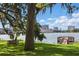 Scenic view of lake featuring a bench and dock, with the city skyline in the distance at 320 Lakeview St # 214, Orlando, FL 32804