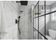 Elegant shower with white marble tile and black fixtures, complemented by modern glass enclosure at 320 Lakeview St # 214, Orlando, FL 32804
