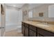 Bathroom features a double sink vanity with a tub-shower combo and neutral color palette at 320 Primrose Dr, Davenport, FL 33837