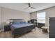 Neutral bedroom featuring a bed, crib, dresser, and ceiling fan at 320 Primrose Dr, Davenport, FL 33837