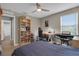 Inviting bedroom featuring neutral walls, a window, hardwood floors, and bookshelf at 320 Primrose Dr, Davenport, FL 33837