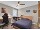 Inviting bedroom with a ceiling fan, desk, and hardwood floors, perfect for studying or relaxation at 320 Primrose Dr, Davenport, FL 33837