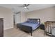Neutral bedroom featuring a bed, crib, dresser, and ceiling fan at 320 Primrose Dr, Davenport, FL 33837