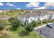 Townhome showcasing a well-kept lawn, with pond views, in a beautiful community and convenient parking at 320 Primrose Dr, Davenport, FL 33837