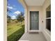 Inviting front entrance with green door, offering views of the surrounding landscape at 320 Primrose Dr, Davenport, FL 33837