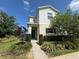 Charming two-story home featuring manicured landscaping, and a welcoming front porch at 320 Primrose Dr, Davenport, FL 33837