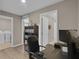 Functional home office space leads to laundry and bathroom; a place for productivity and convenience at 320 Primrose Dr, Davenport, FL 33837