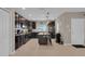 Spacious kitchen features dark wood cabinets, an island with seating, and granite countertops at 320 Primrose Dr, Davenport, FL 33837
