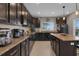 Bright kitchen features dark wood cabinets, stainless appliances and granite countertops at 320 Primrose Dr, Davenport, FL 33837